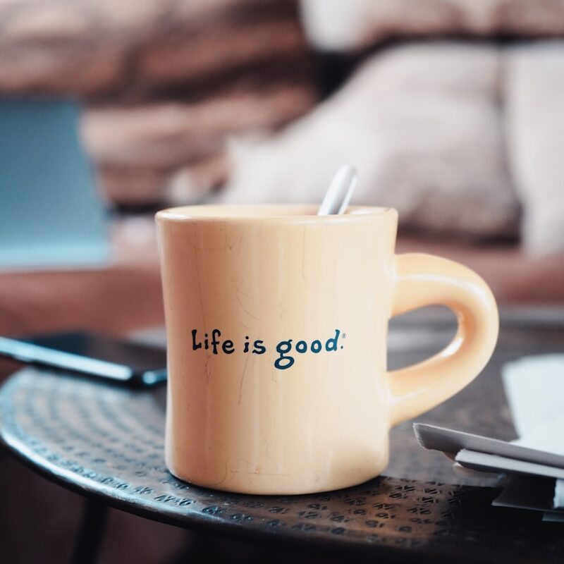 brown ceramic mug on blue and white ceramic plate